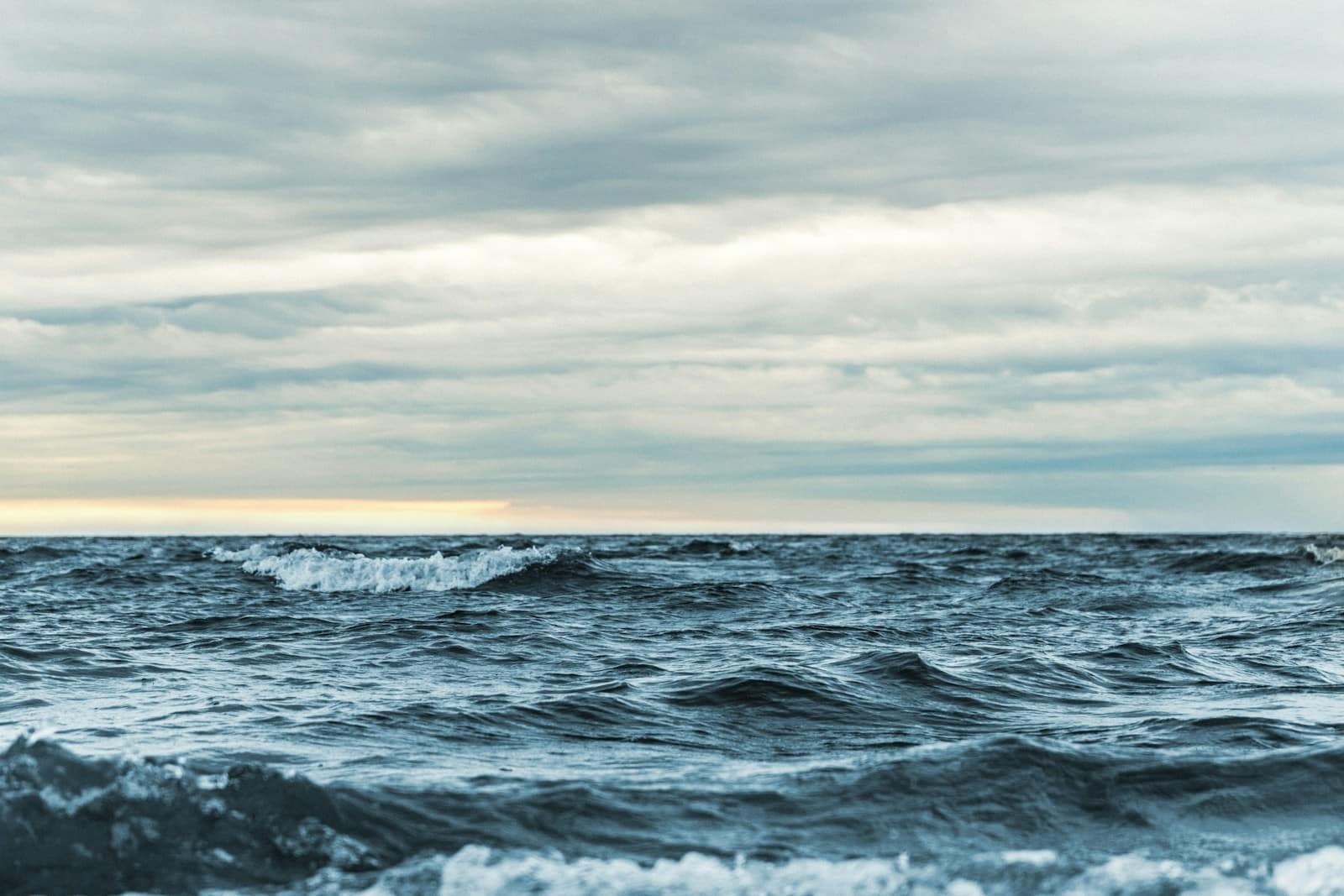 Rhythmic ocean waves under a bright sky